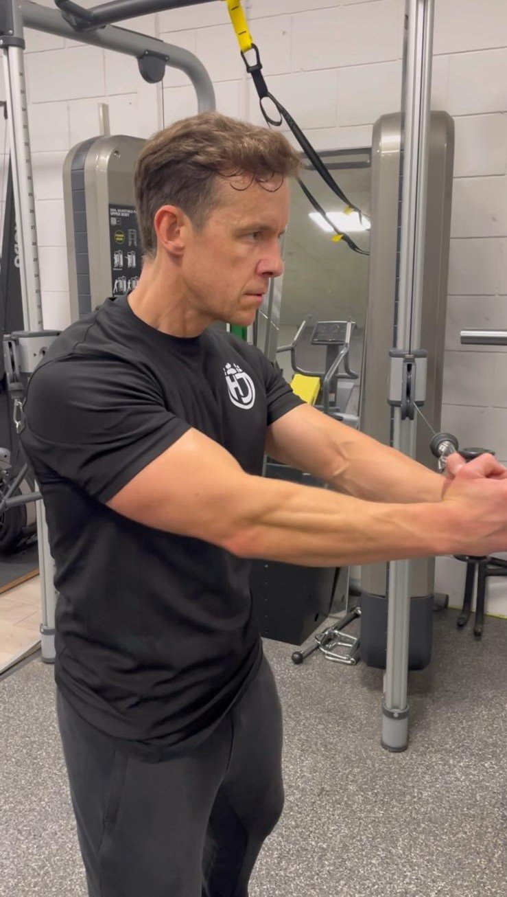 Cable exercise demonstrating the brace and rotation movement pattern