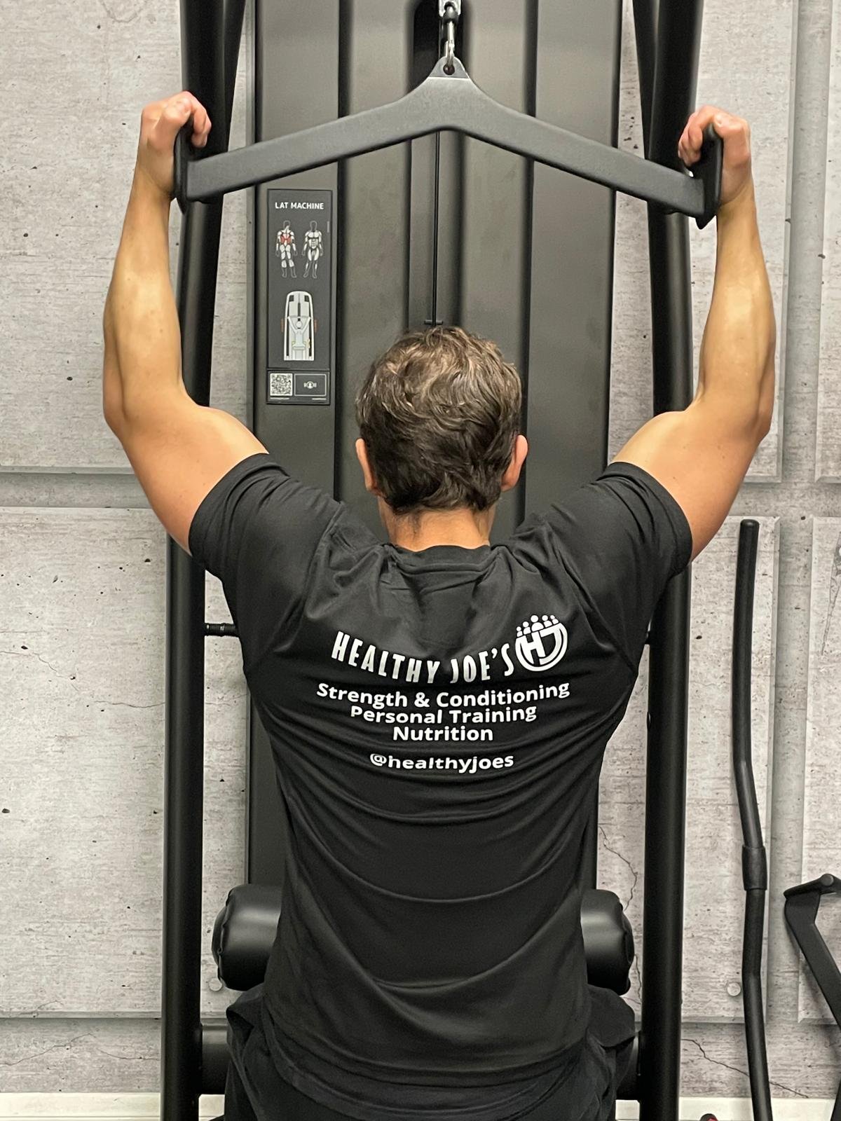 Joe Petherwick training in the gym wearing Healthy Joe’s branded clothing