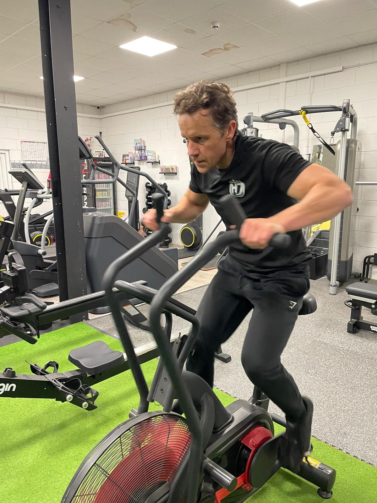 Joe Petherwick using an AirBike during a strength and conditioning session