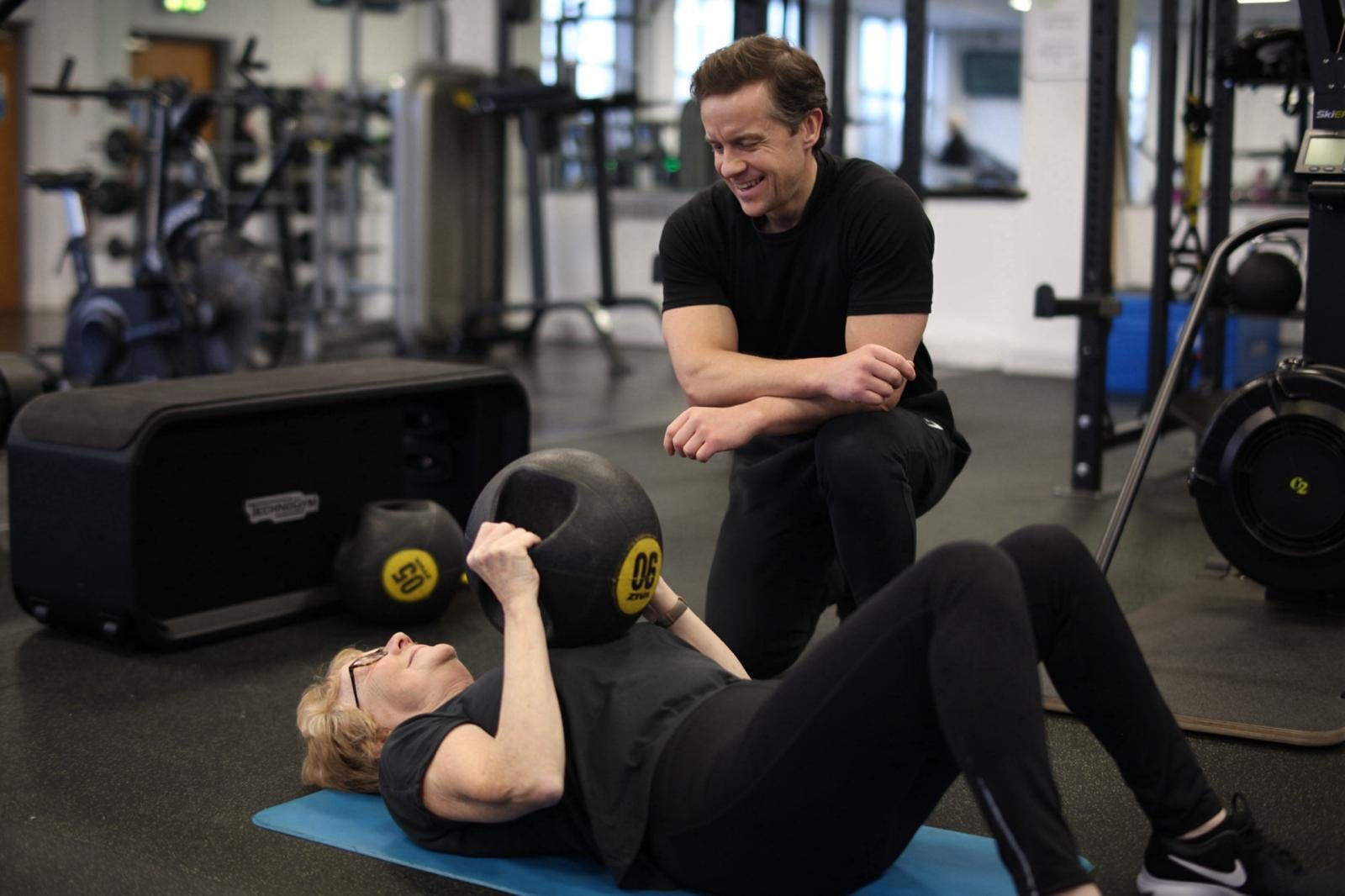 Joe Petherwick coaching a client during floor based exercise
